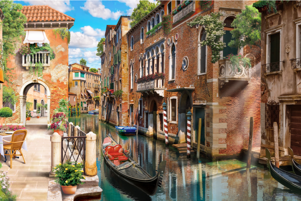 empty boat on charming canal in Venice italy with cute villas on either side and no one around