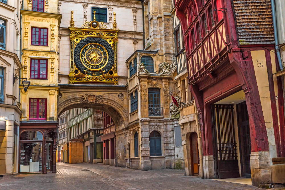 Old cozy street in Rouen with famos Great clocks or Gros Horloge of Rouen, Normandy, France.