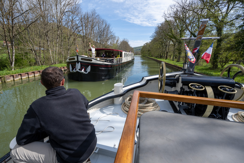 Barges passing the Canal de Bourgogne in Burgundy, France.