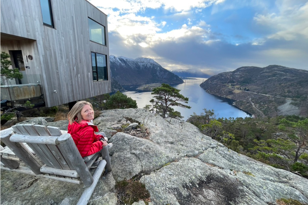 Brook sitting on a wooden chair overlooking the Lysefjord.