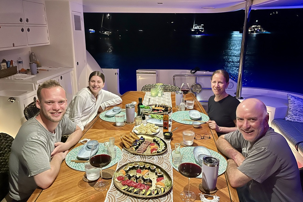 Travelers having dinner on a boat yacht charter.