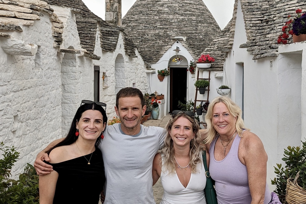 Travelers Isabel, Mario, Julia, and Martha Queiroz in the town of Alberobello, Puglia, Italy.