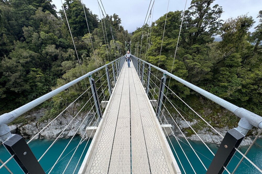 Traveler Sandra McLaughlin on the Hokitika Gorge suspension bridge, New Zealand.