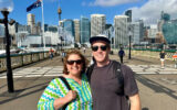 Two travelers at Darling Harbour Pyrmont Bridge in Sydney, Australia