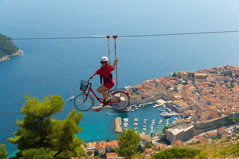 A woman on the Sky Bike overlooking the city of Dubrovnik, Croatia.