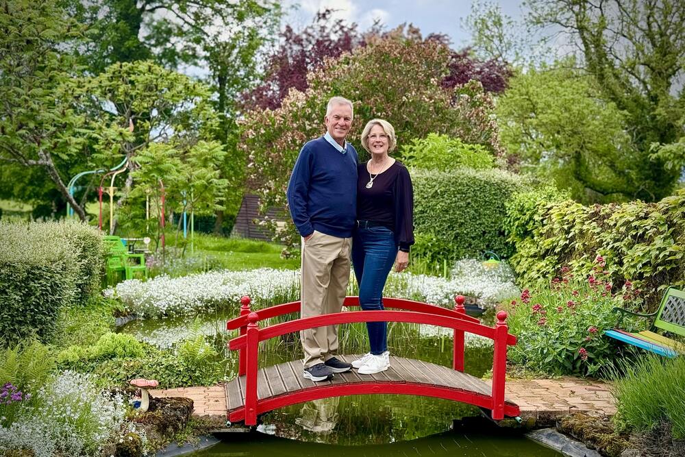 Bill Fisher and his wife in the garden before dinner at the home of their barge captain's parents, France.