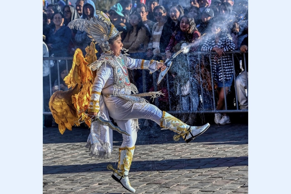 Boy ‘angel’ spouting fire during the parade in Cusco, Peru.