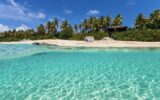 Tropical beach with white sand, turquoise ocean water and blue sky at Virgin Gorda, British Virgin Islands in Caribbean.