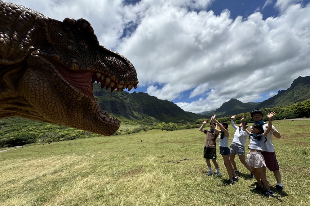 Jennifer Cheng's family with a dinosaur puppet that the guide brought during their UTV raptor tour at Kualoa Ranch, Hawaii.