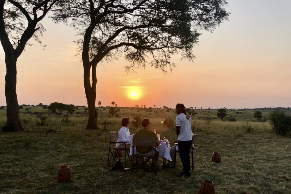 Karen and Rod Baesman enjoying a private dinner for their WOW Moment in Murchison Falls National Park in Uganda.