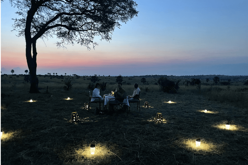 Karen and Rod Baesman enjoying a private dinner for their WOW Moment in Murchison Falls National Park in Uganda.