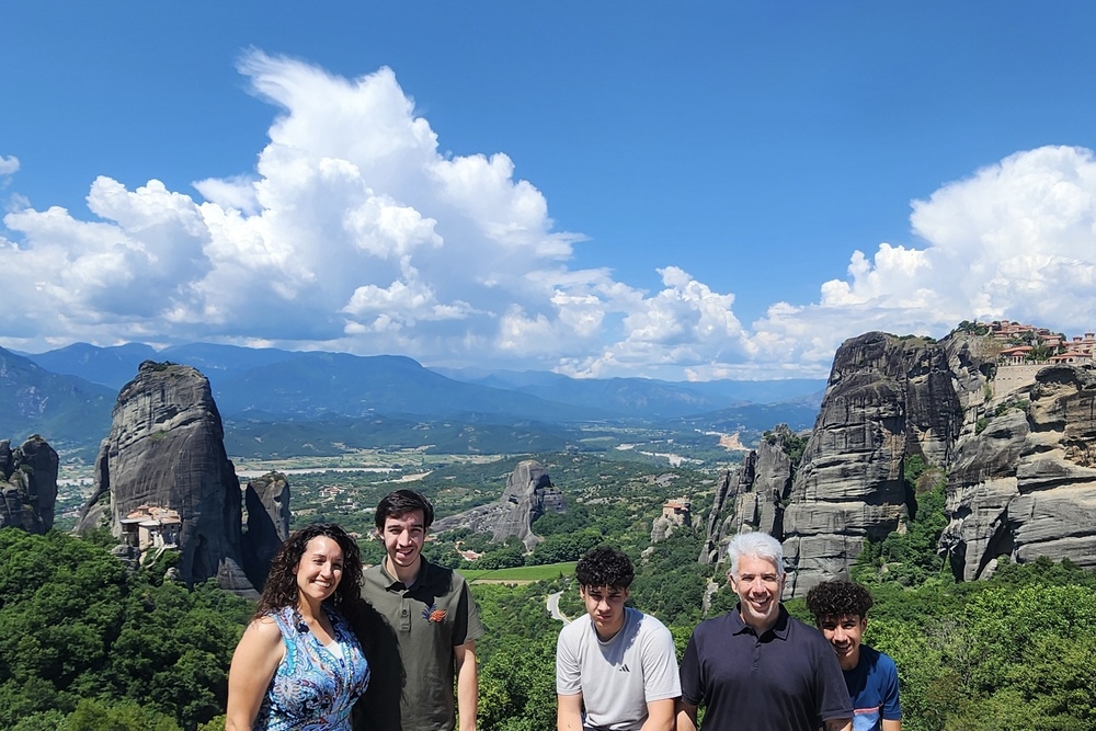 Nelson Mongiovi and his family in Meteora with three monasteries in the background, Greece.