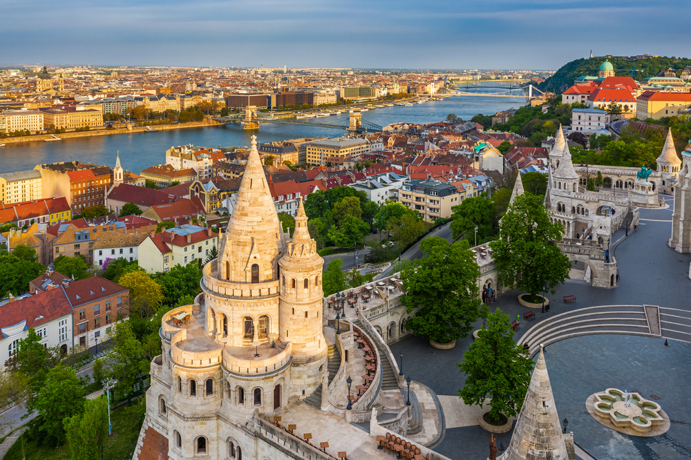 The aerial view of of Fisherman's Bastion at sunset with Szechenyi Chain Bridge on the background, Budapest, Hungary.