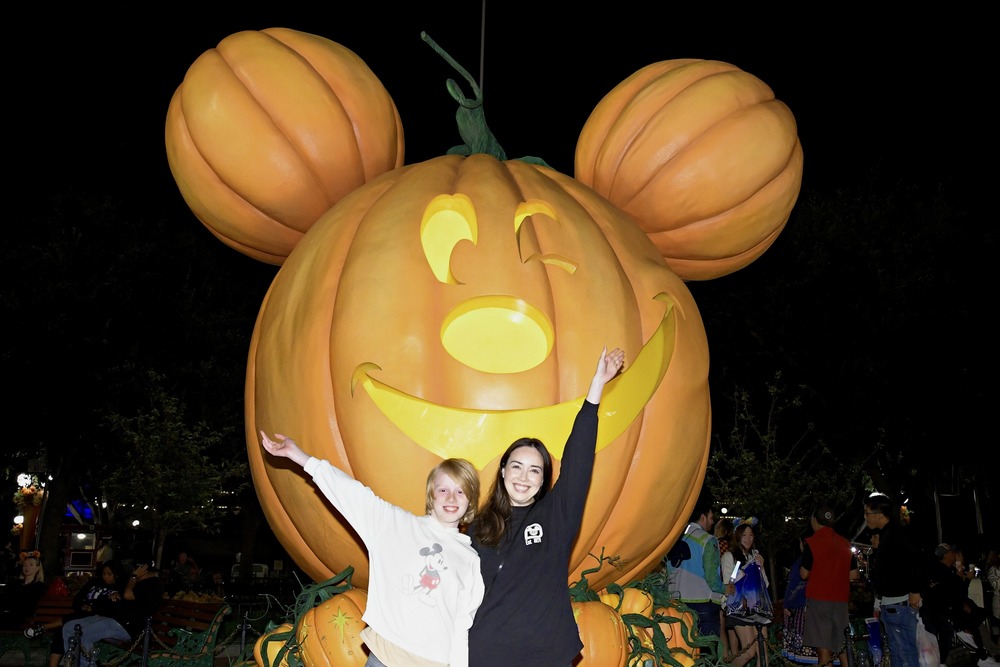 Christie Bartram and her son next to Mick-o-lantern in Disneyland, California.