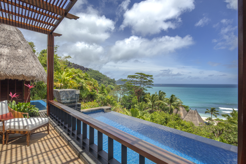 The pool and ocean view from a guest room in Anantara Maia Seychelles Villas.