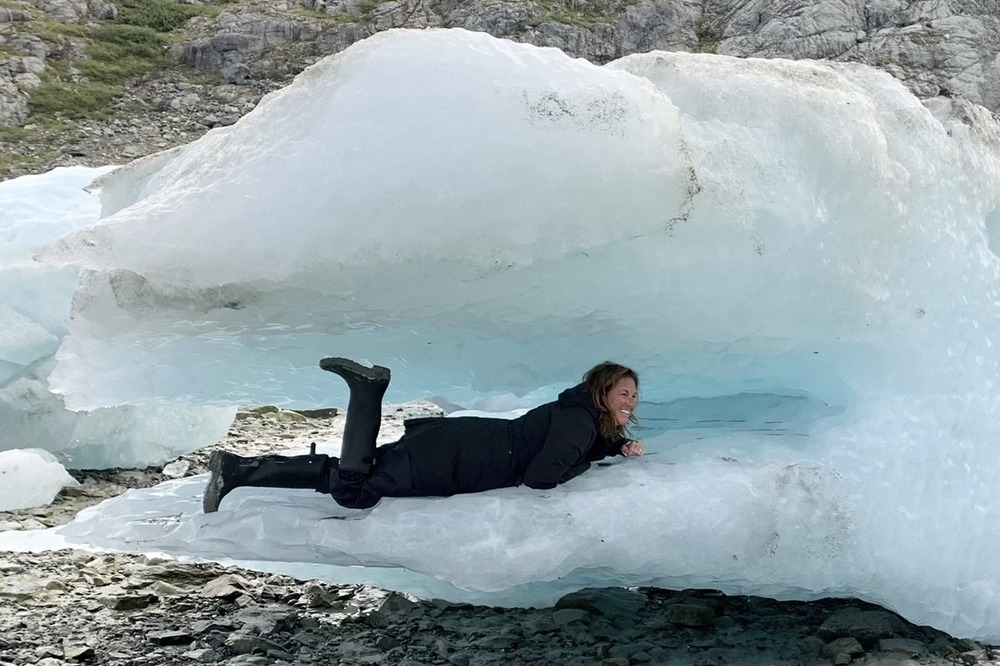 Jackie Mandel inside a broken piece of ice from Lamplugh Glacier, Alaska.