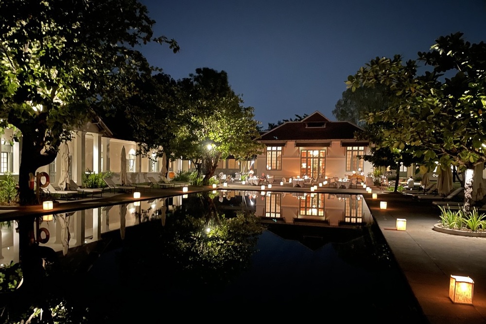 A lantern-lit dinner by the pool at Amantaka hotel in Laos.