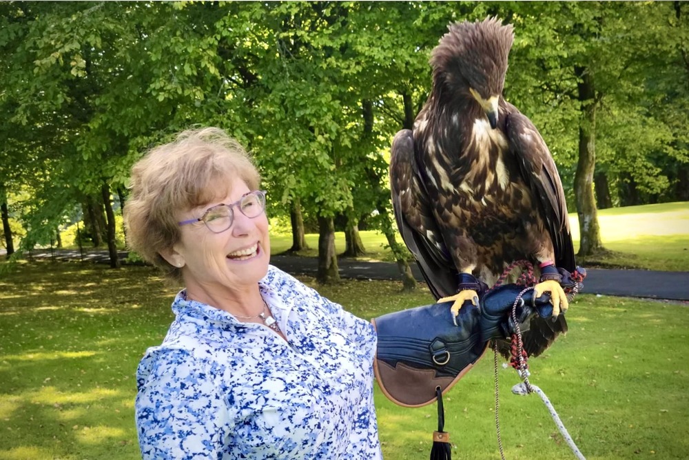 Michele Block holding a falcon in Helmsdale, Scotland.