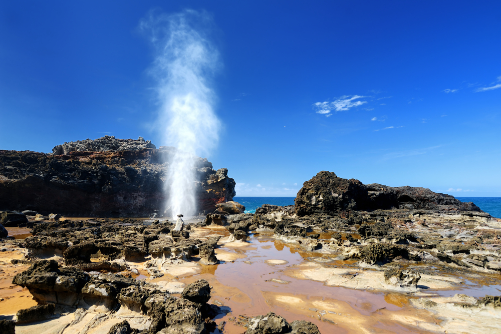 Nakalele blowhole, jet of water and air forced out through the hole in the rocks on Maui coastline, Hawaii.