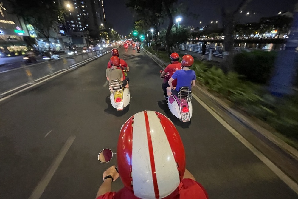 Riding scooters in Saigon city at night, Vietnam.