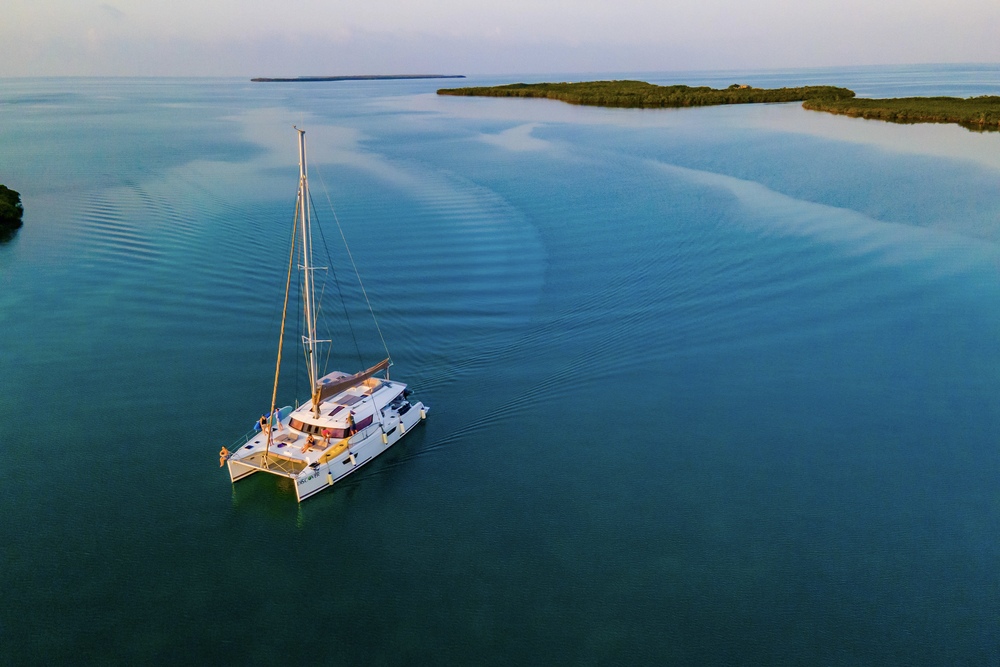 Drone shot of catamaran sailing in Belize.