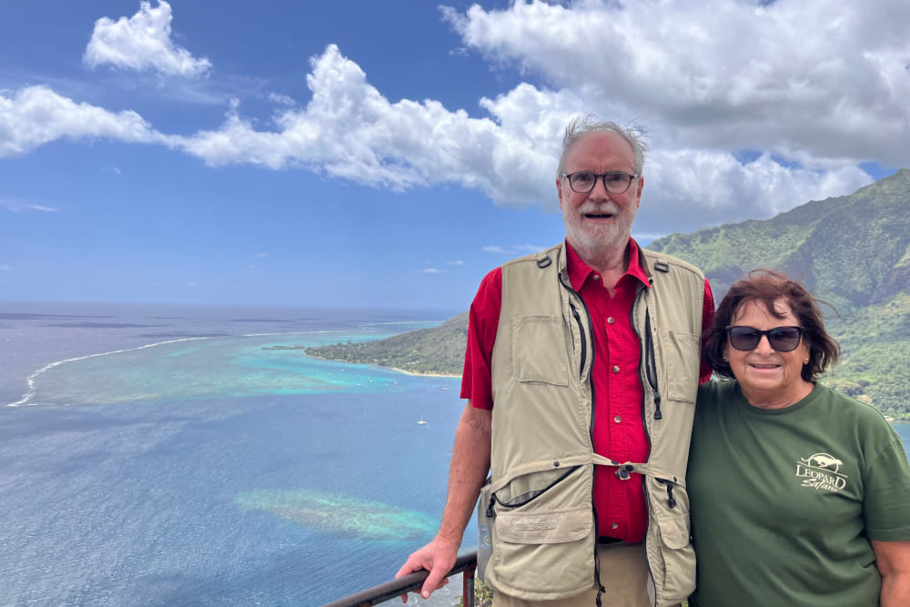 Jan and Jamie Heininger on a balcony overlooking coast of Moorea.