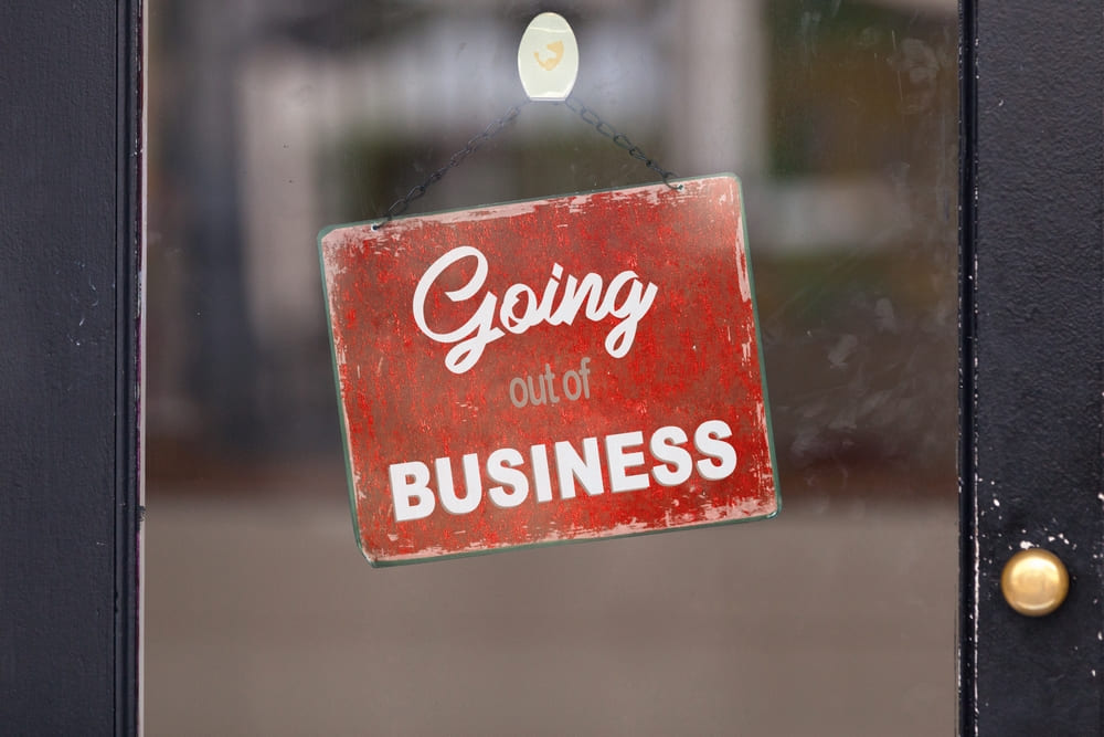 Red closed sign with " Gping out of business " written on it.