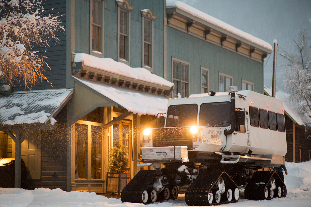 Snowcat outside building, Rocky Mountains.