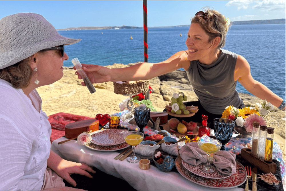 Wendy Perrin having a picnic on the beach on Gozo Island, Malta.