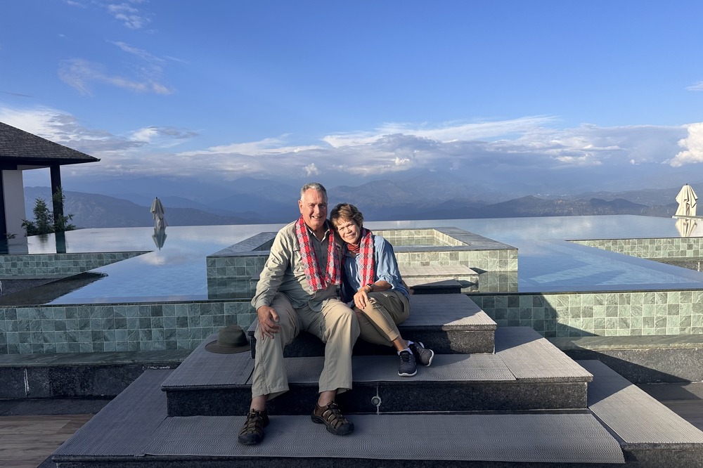 Christine Stoll and husband in front of a pool at Dusit Thani Himalayan Resort in Dhulikhel, Nepal.