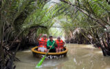 Floating through Vietnam’s coconut flower groves on a bucket boat.