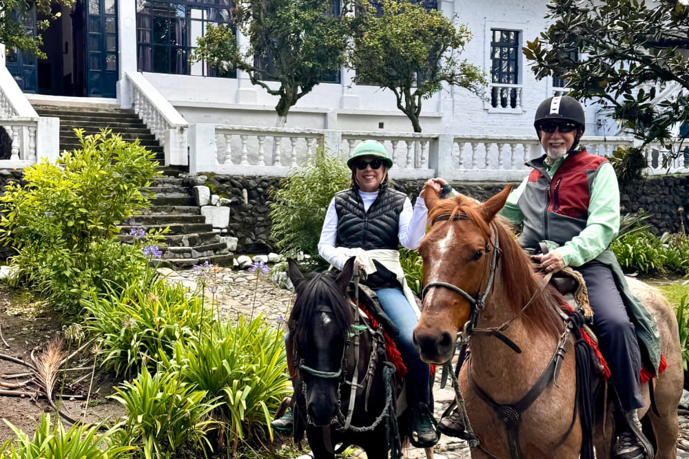 Barbra and Eugene Hirsch horseback riding in Hacienda Pinsaqui, Ecuador.