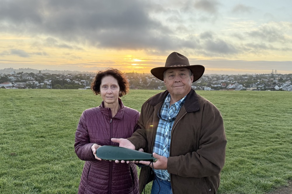 Brent and Kathy Larsen holding a Māori pounamu.