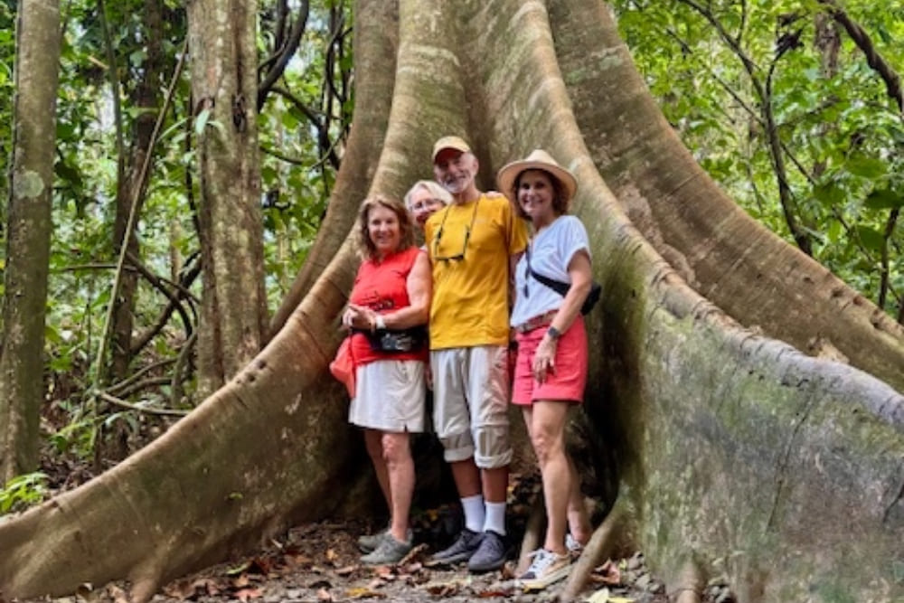 Group of friends posing next to a massive tree on Costa Rica’s Osa Peninsula.