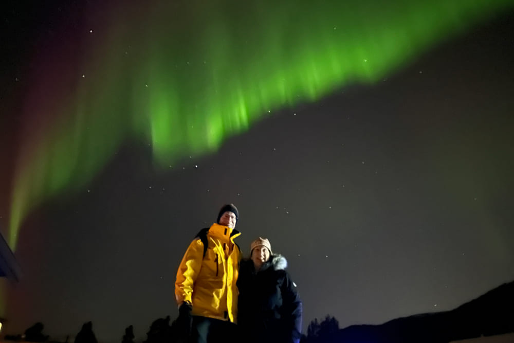 Jerry and Carol Huller in Alta, Norway, in front of Aurora Borealis.