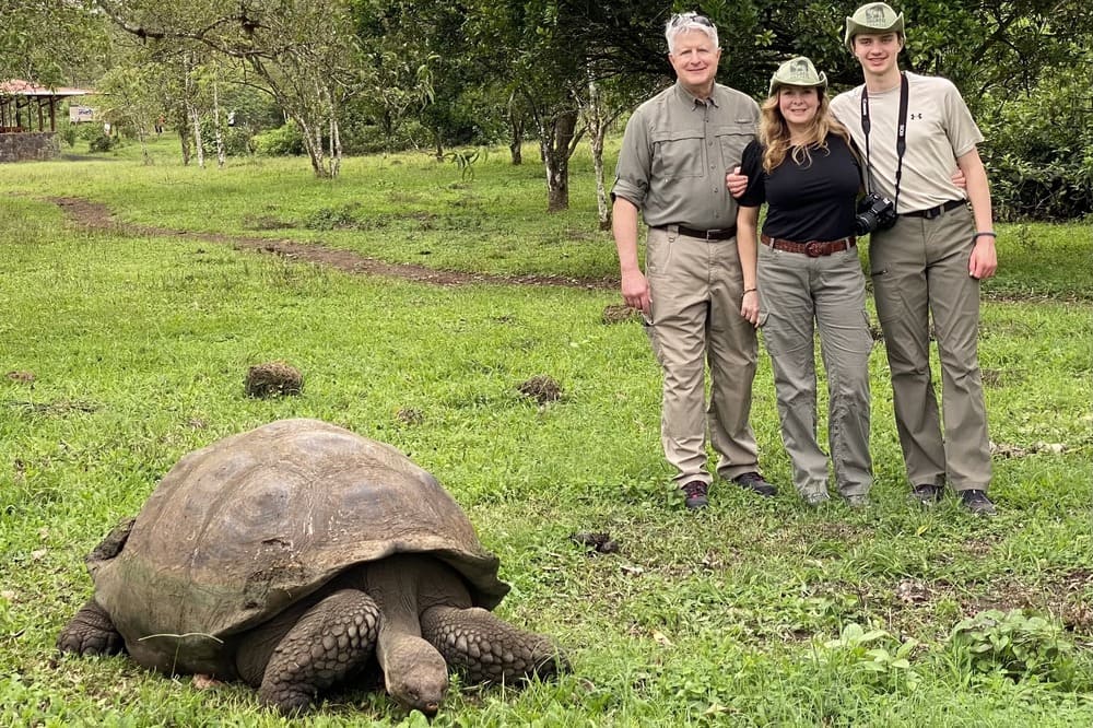 Shelby Willets and her family posing with a giant tortoise in the Galapagos, Ecuador.