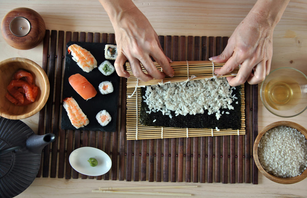 Close up of hands making sushi in Japan.