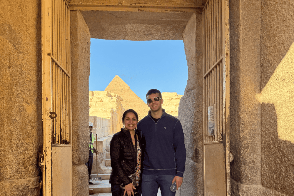 Tina Hunt standing in a doorway with the Giza pyramids in the background.