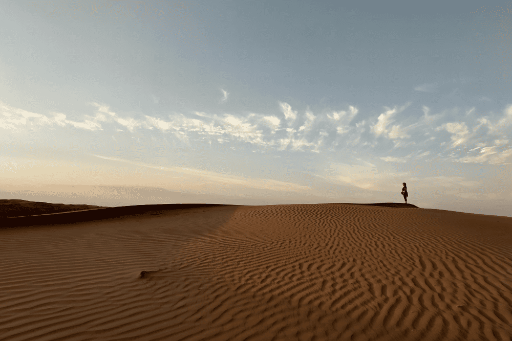 Jenifer Bunis in the Wahiba Sands desert at sunset.