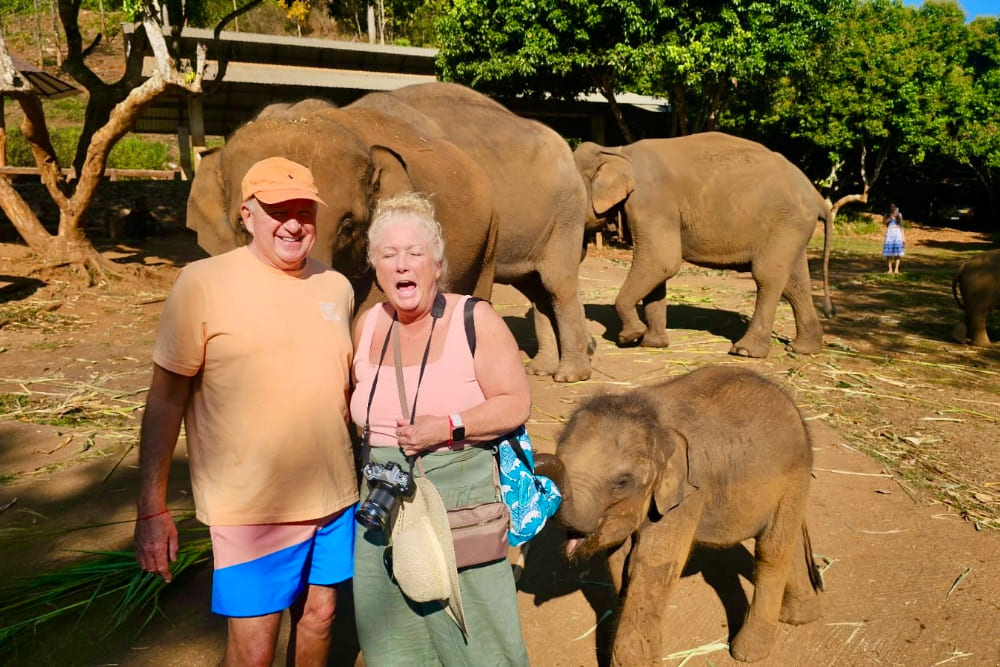 Ted and Kathie Embacher surprised by a baby elephant.